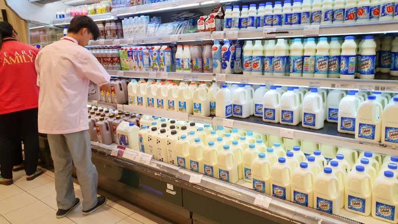 a_staff_member_arranges_bottles_of_milk_in_the_supermarket_at_aeon_mall_in_phnom.jpg