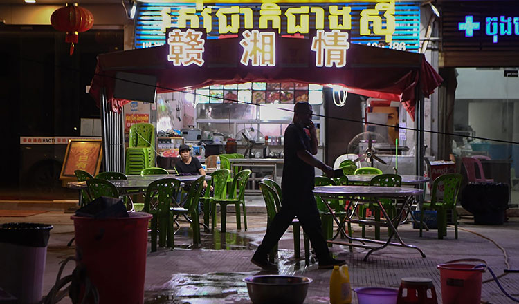 A-man-walking-past-a-Chinese-restaurant-in-Sihanoukville-1.jpg